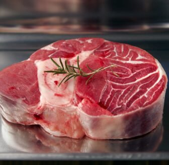 Closeup of piece of leg angus steak with rosemary